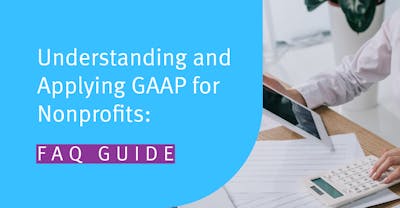 Accountant using a calculator and tablet